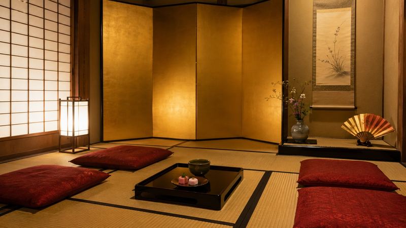 A geiko performing a traditional dance at a Kyoto teahouse