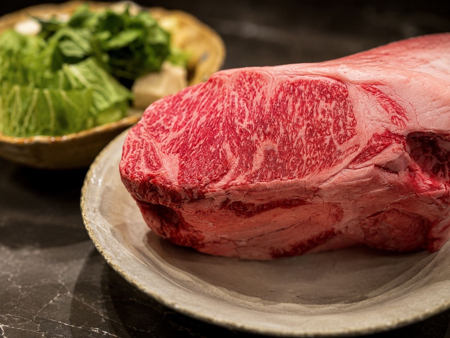 A chef searing wagyu beef during a cooking class in Kyoto